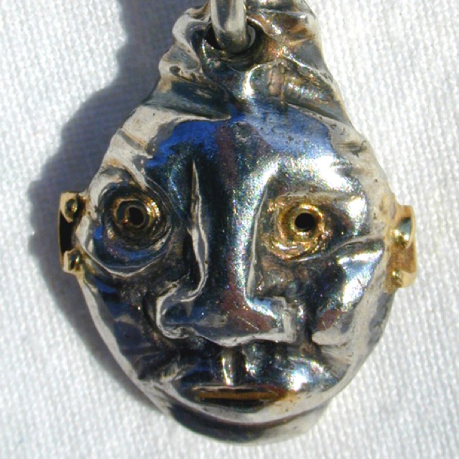 93-07 : Negroïde kop - zilver en goud